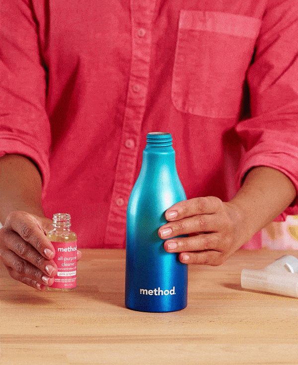 refilling a spray bottle from concentrate, then spraying